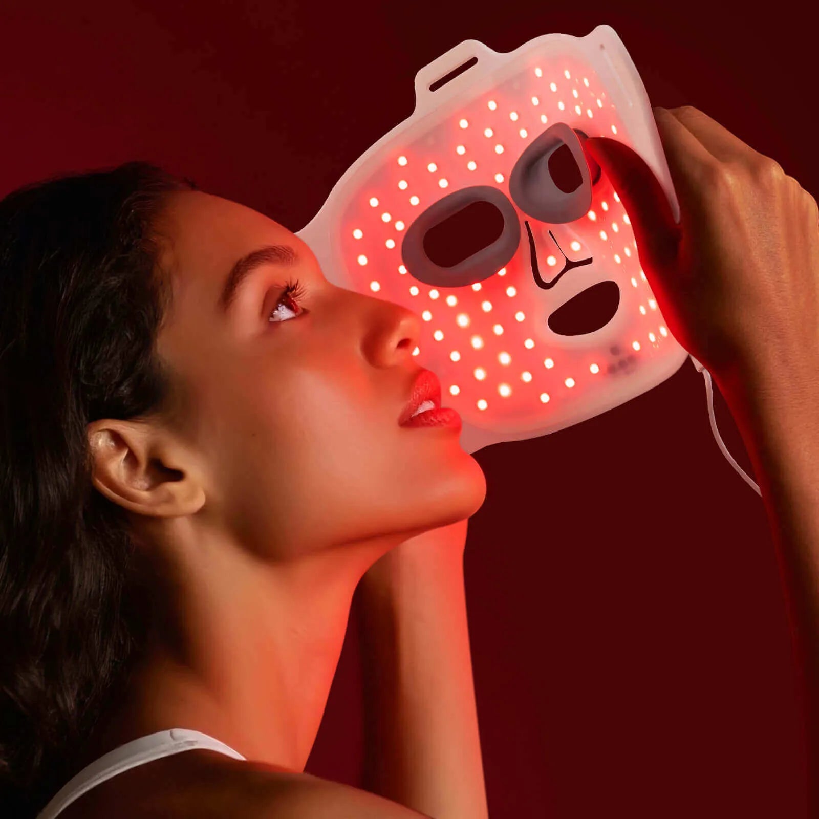 User adjusting Umitec LED Face Mask with soft straps and flexible fit for comfortable use