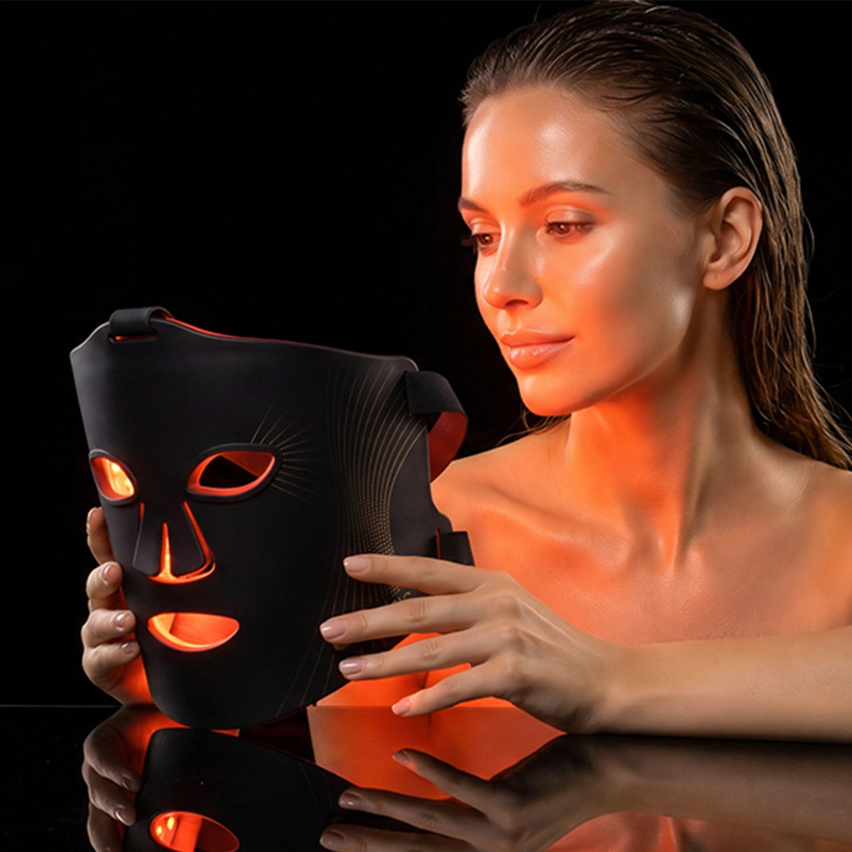 A women holds the Black Umitec LED Face Mask in anti-aging mode